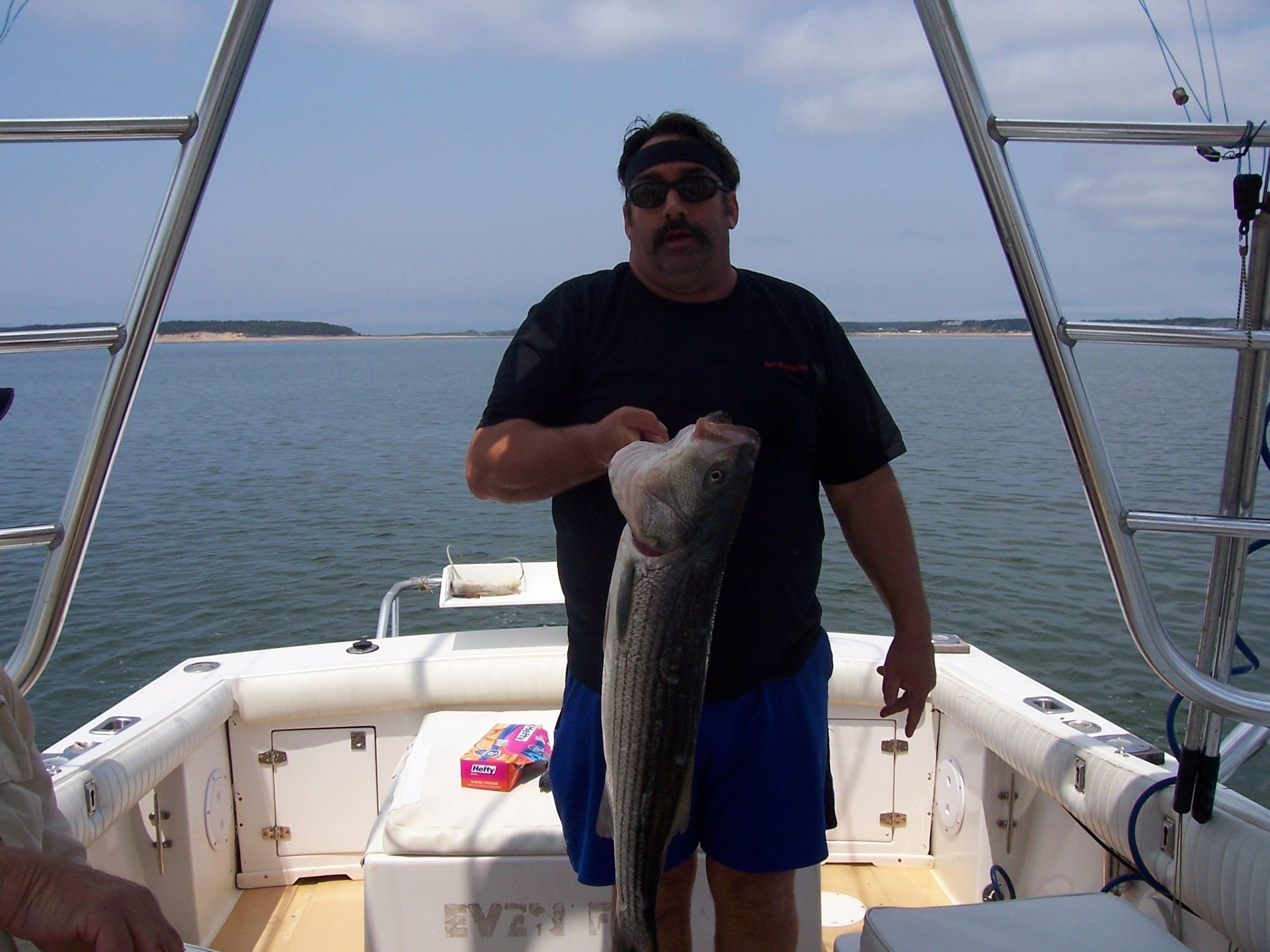 Man Holding Striper Fish with One Hand